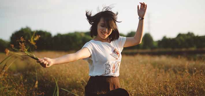 Girl in field with flowers