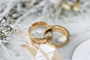 Two wedding rings on a white tablecloth